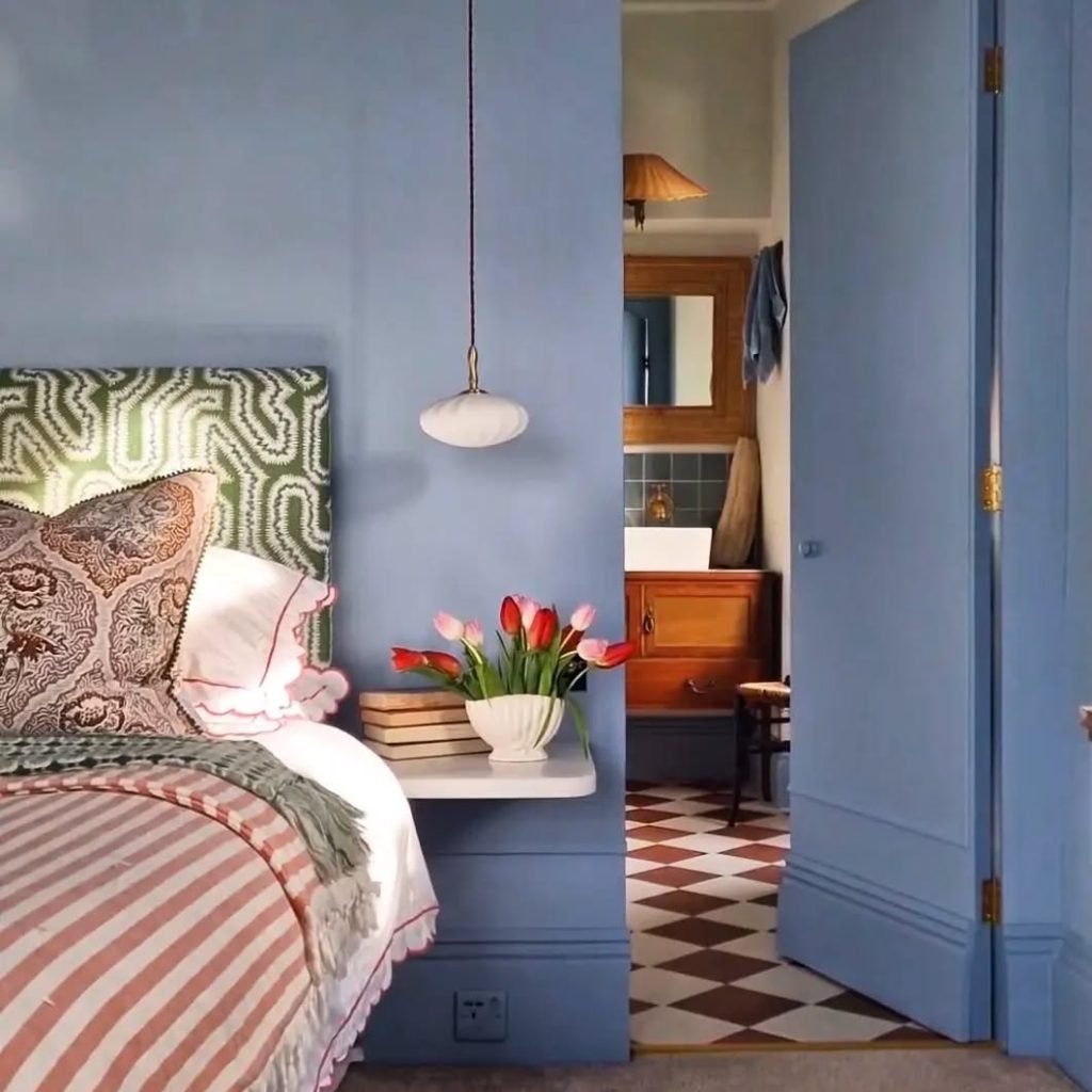 Artistic Blue Bedroom with Green Headboard & Tulips