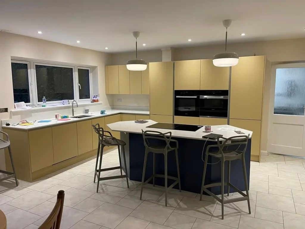 Minimalist Butter Yellow Kitchen with Navy Island