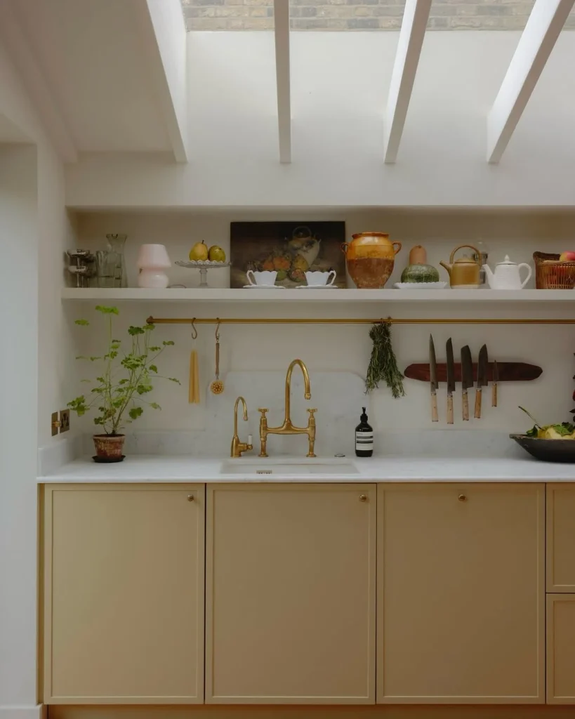 Skylit Butter Yellow Kitchen with Brass Fixtures
